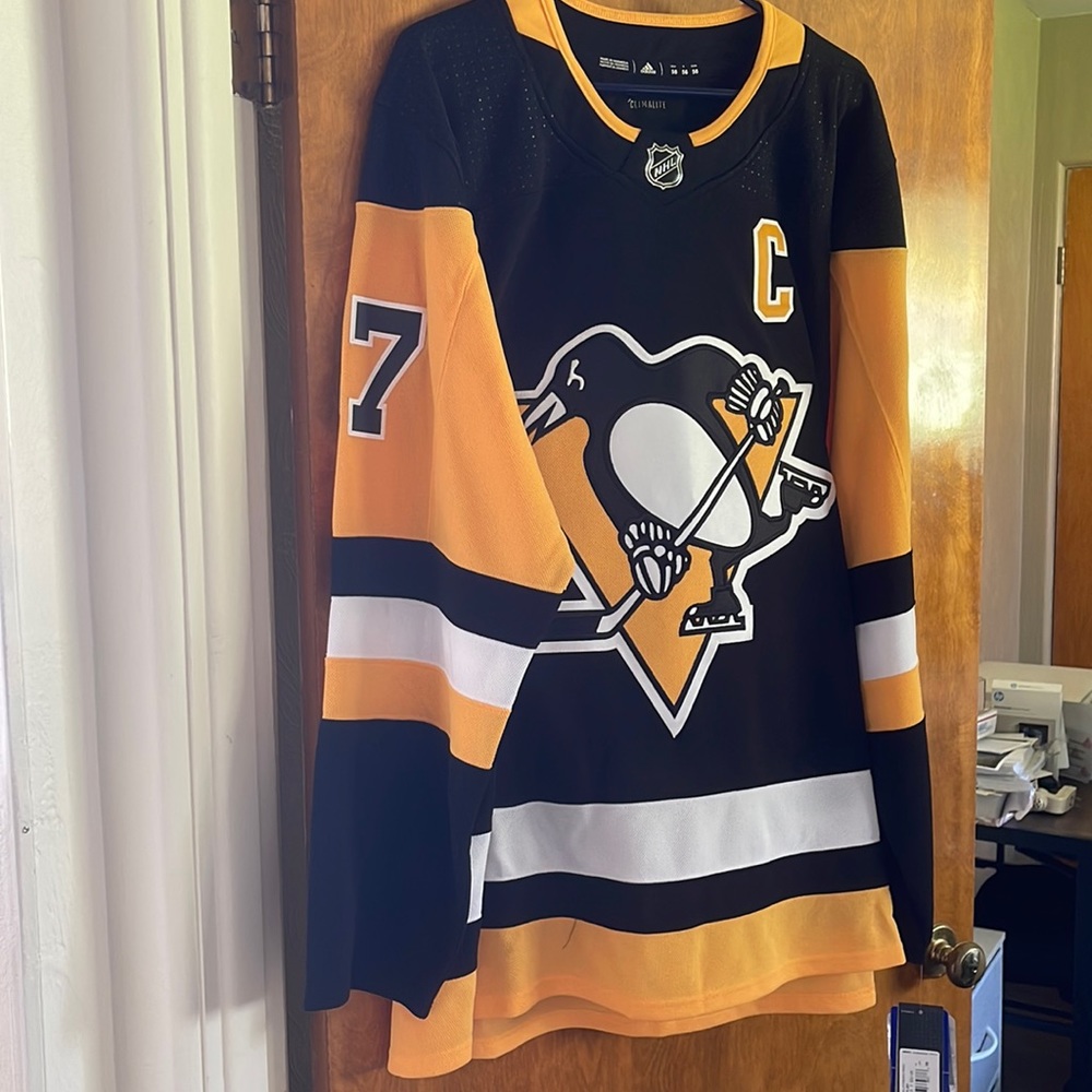 Mens authentic Pittsburgh penguins jersey with fight strap.